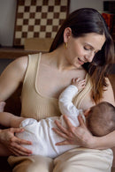 femme portant une camisole d'allaitement et allaitant son enfant